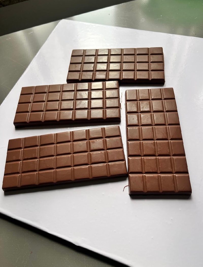 Four finished chocolate bars on a white board